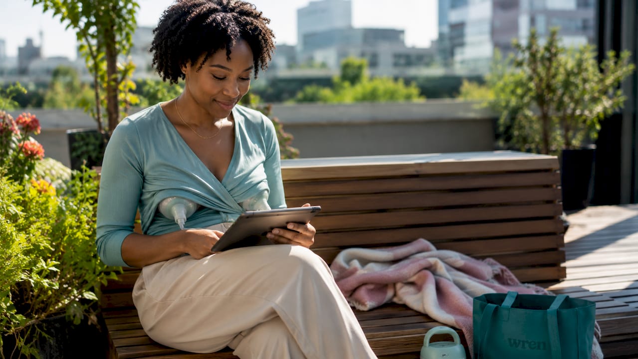 Woman using wearable breast pump at work