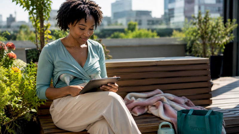Woman using wearable breast pump at work
