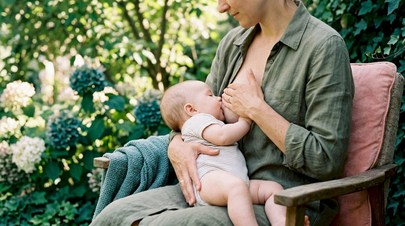 Mother gently compressing breast during feeding