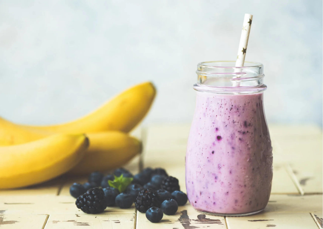A picture of a smoothie, blueberries and bananas