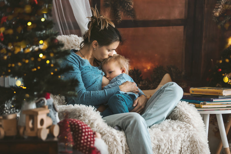 Woman breastfeeding her child at Christmas
